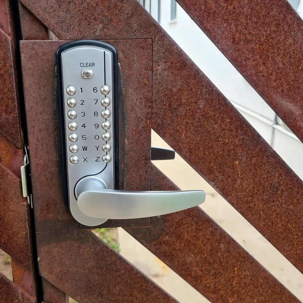 Mechanical push-button lock installed on a gate