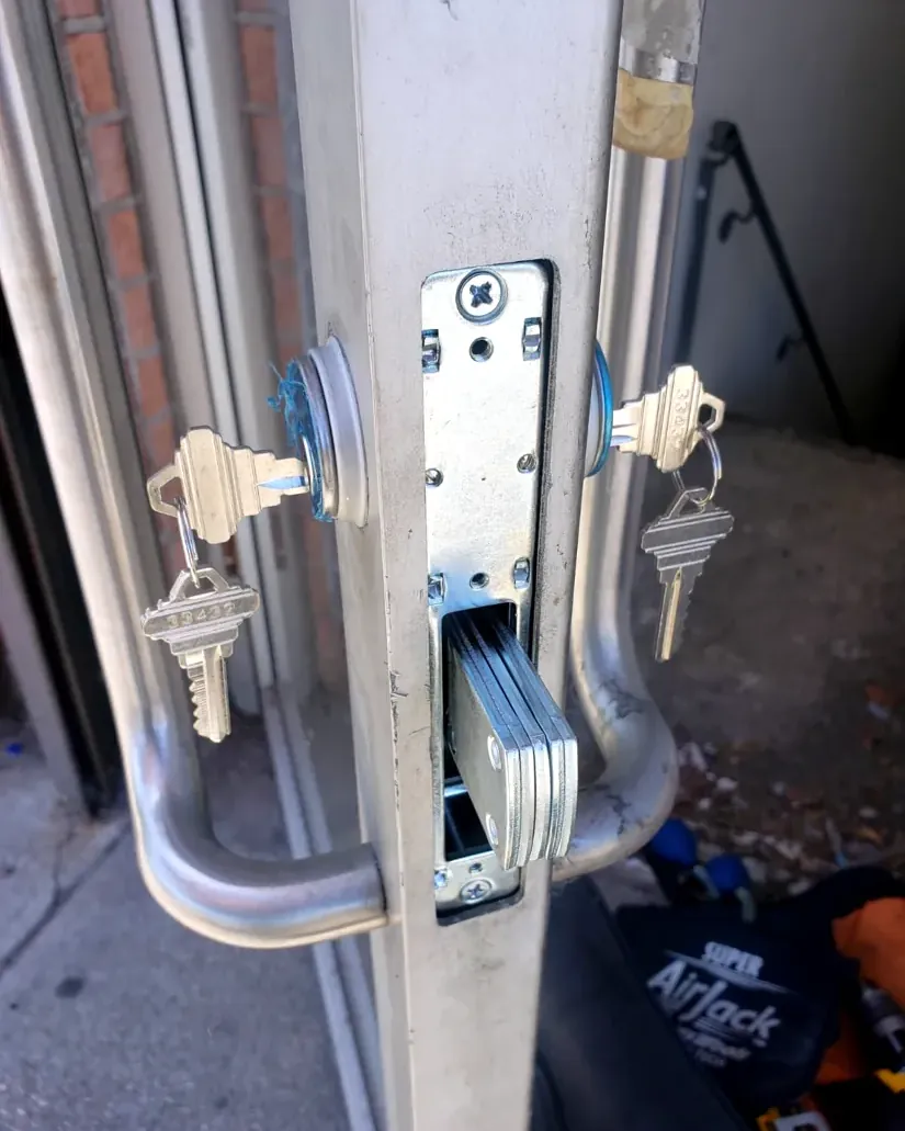 Storefront door lock being repaired by a commercial locksmith in Nassau County, NY