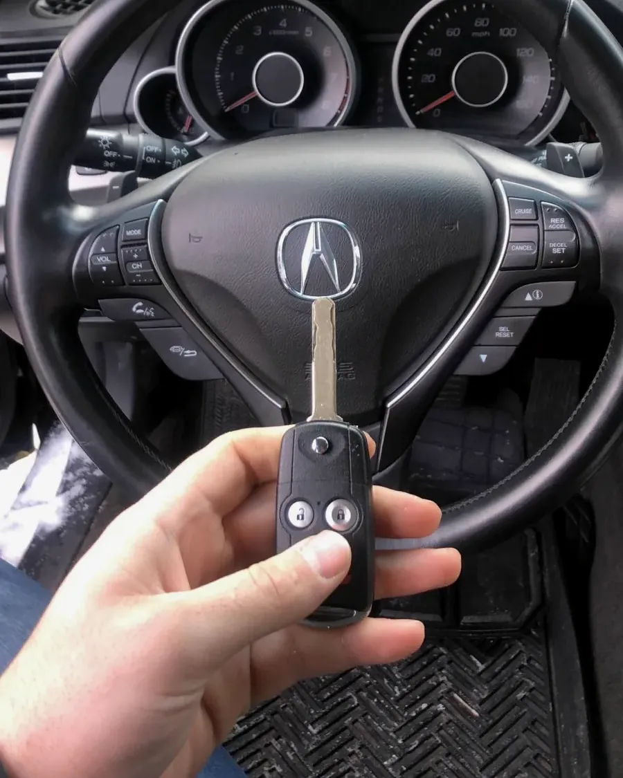 New Acura remote flip key held at the steering wheel after a job in Lynbrook, NY