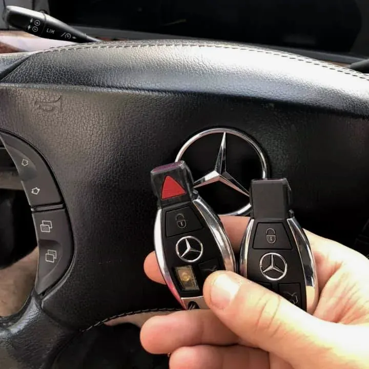Two Mercedes-Benz smart keys at the steering wheel