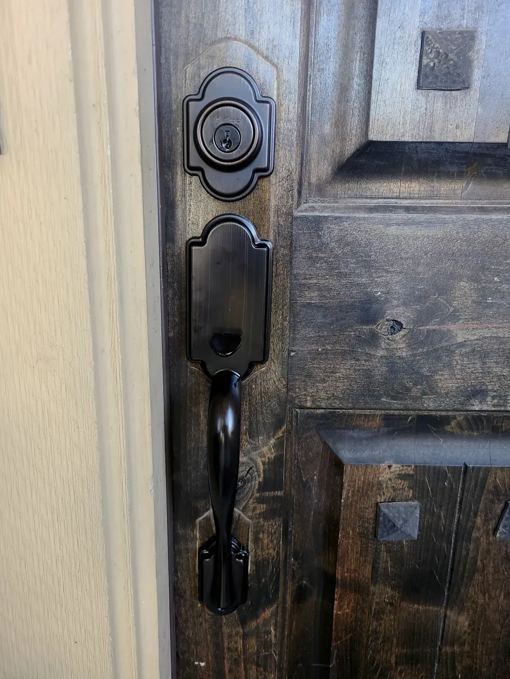 Deadbolt and handleset on a wood entry door