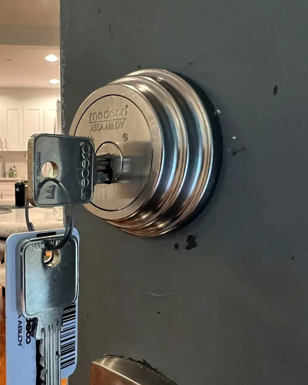 High-security deadbolt with a new set of keys on a home door in Nassau County, NY
