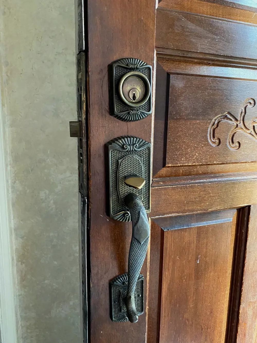 Bronze handleset and deadbolt on a wood entry door