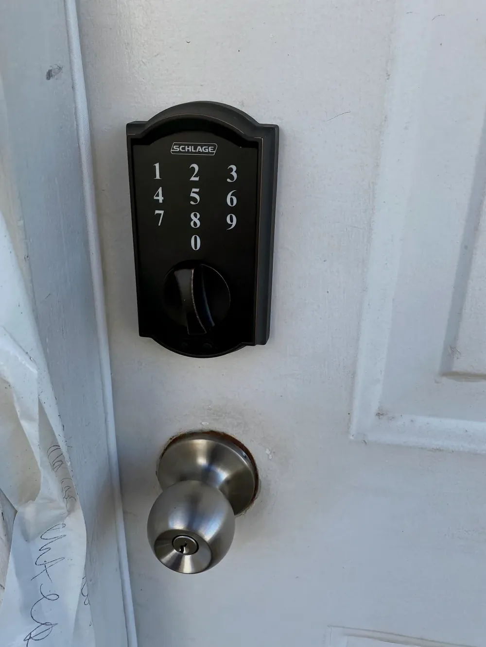 Schlage touchscreen keypad deadbolt above a knob lock